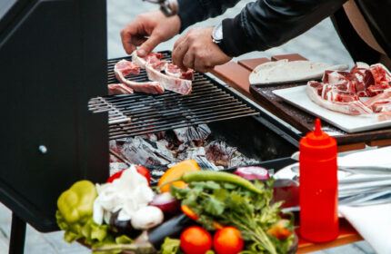 Meat ribs on grill with vegetables